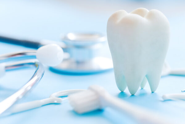 Dental model and dental equipment on blue background, concept im
