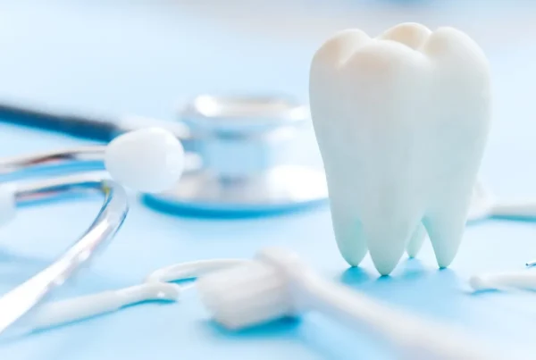 Dental model and dental equipment on blue background, concept im