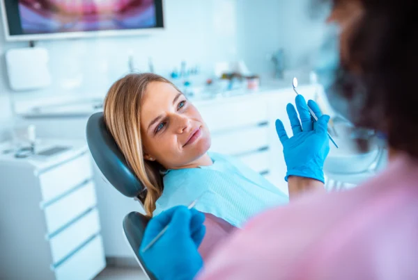 Dentist examining a patient's tooth during a dental exam